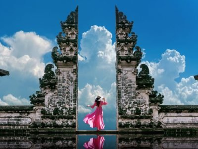 A female with a pink dress standing at Temple gates at Lempuyang Luhur temple in Bali